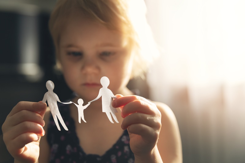 little girl with paper family in hands. concept of divorce, cust Collaborative divorce The Hill Law Firm AdobeStock_330330289