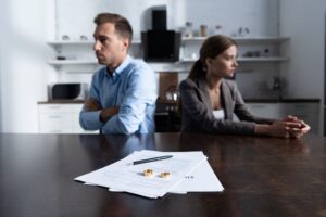 collaborative divorce The Hill Law Firm Kansas CIty AdobeStock_293652831 selective focus of couple sitting at table with divorce documents